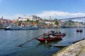 Typical boats of the Douro River in Oporto. Panoramic views of the historic city center of Porto in Portugal.