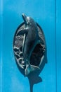 Typical Brass Dolphin Door Knocker On A Blue Door In Gozo,  Malta