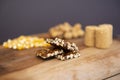 Typical brazilian June Party Festa Junina foods on a wooden table: peanuts candies paÃÂ§oca and pe-de-moleque corn kernels,