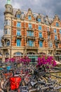 Typical bridge over a canal with many bikes and flowers in Amsterdam, Holland. Royalty Free Stock Photo