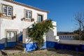 Typical brightly colored blue and white building in Obidos Portugal, a stonewalled city in a castle