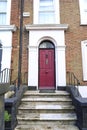 Typical British house with colorful pink door in Bristol