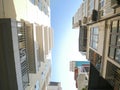 Typical caged-balcony apartment and multistory residential houses at small back alley in downtown Hanoi, Vietnam, lookup view Royalty Free Stock Photo