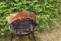 camping barbecue with bushes in the background