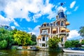 Typical Canal Scene with Historic Aristocratic Houses in Amsterdam under blue sky Royalty Free Stock Photo