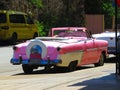 Typical car from Havana, Cuba. Photo from the street. Rear view pink car.
