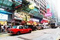 Typical city life at Nathan Road, Hong Kong. Passerby and road traffic, buildings and signs. Royalty Free Stock Photo