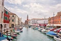 Typical city view Chioggia town from the bridge in venetian lagoon, water canal, church, typical architecture, boats Royalty Free Stock Photo