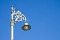 Typical classic Irish streetlight against a blue background - image with copy space