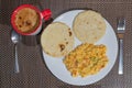Typical colombian breakfast with criollo eggs, arepas and coffee