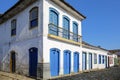 Typical colonial two and one story houses with colorful doors and windows on sunny day in historic town Paraty, Brazil, Unesco Royalty Free Stock Photo