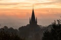 A typical colorful Autumn sunrise in Maastricht with the landscape covered with a layer of fog, leaving only silhouettes visible i Royalty Free Stock Photo