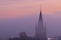 A typical colorful Autumn sunrise in Maastricht with the landscape covered with a layer of fog, leaving only silhouettes visible i Royalty Free Stock Photo