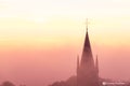 A typical colorful Autumn sunrise in Maastricht with the landscape covered with a layer of fog, leaving only silhouettes visible i Royalty Free Stock Photo