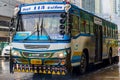 Typical colorful blue decorated bus in heavy rain Bangkok Thailand