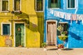 Typical colorful house of Burano Island with hanging laundry at its facade Royalty Free Stock Photo