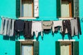 Typical colorful house of Burano Island with hanging laundry at its facade Royalty Free Stock Photo