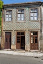 Typical Colorful Portuguese Architecture: Tile Azulejos Facade with Antique Windows And Balcony - Portugal Royalty Free Stock Photo