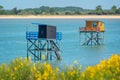 Typical and colorful wooden fishing huts on stilts in the atlantic ocean near La Rochelle France