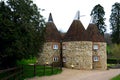 Typical converted Oast House in a remote setting in a village in Kent, England, UK. Oast houses in group constructed Royalty Free Stock Photo