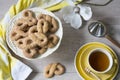 Typical cookies from The Netherlands called Krakeling, with cup of tea and flower Royalty Free Stock Photo