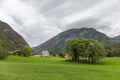 Typical countryside Norwegian landscape with house. Cloudy summer morning in Norway, Europe. Beauty of nature concept background. Royalty Free Stock Photo