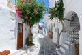 The typical cycladic, whitewashed alleys with colorful flowers at Parikia on the island of Paros Royalty Free Stock Photo