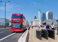 Typical double decker buses on the London Bridge with a view of the City Royalty Free Stock Photo