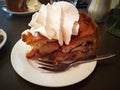 Typical Dutch dish. apple pie, the best cake in all of Amsterdam. apple pie accompanied by a lot of whipped cream and placed on a