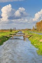 Typical Dutch flat polder landscape with cana and bridges Royalty Free Stock Photo