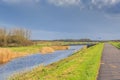 Typical Dutch flat polder landscape with canal and bridge Royalty Free Stock Photo