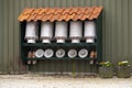 Typical Dutch image of empty traditional milk containers under a tiled roof Royalty Free Stock Photo