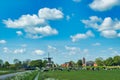 Typical Dutch landscape with cows, a windmill and an old village Royalty Free Stock Photo