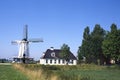 Typical dutch landscape with farm and windmill Royalty Free Stock Photo