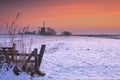 Typical Dutch landscape with windmill in winter at sunrise Royalty Free Stock Photo