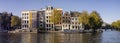 Typical Dutch mansion houses on a canal in autumn light in Amsterdam