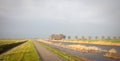 Typical dutch open landscape on a windy day stormy sky Royalty Free Stock Photo