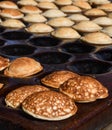 Typical Dutch poffertjes - tiny pancakes-being baked on a heavy cast iron pan Royalty Free Stock Photo