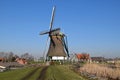 Typical Dutch polder landscape with an old mill with thatched cover. Royalty Free Stock Photo