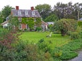 Typical English cottage on a summersday surrounded by the village stream with a lustrous garden