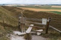 Typical english country stile with dog gate leading to meadow Maiden Castle Dorset Dorchester United Kingdom Royalty Free Stock Photo