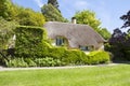 Typical English thatched roof cottage. Royalty Free Stock Photo