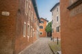 Typical European stone path in lane from Via Stazione leading to orange building at end