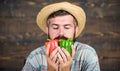 Typical farmer guy. Farm market harvest festival. Man mature bearded farmer hold vegetables wooden background. Sell Royalty Free Stock Photo