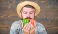 Typical farmer guy. Farm market harvest festival. Man mature bearded farmer hold vegetables wooden background. Sell Royalty Free Stock Photo