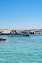 Typical fishing boat on crystal clear turquoise sea water Royalty Free Stock Photo