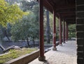 Rows of red stone pillars in a Chinese-style garden building.