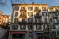 Typical four-story stone building with balconies in downtown Lausanne Switzerland during the sunset