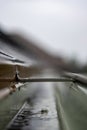Selective focus on a section of residential guttering with hanger conveying water during a storm. Rain splatters and Royalty Free Stock Photo