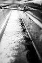 Selective focus on a section of residential guttering with hanger conveying water during a storm. Rain splatters and Royalty Free Stock Photo